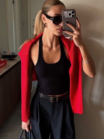 Independent designer Red sweater over shoulder draped available to rent